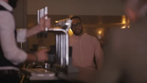 4K Friendly Bartender Serving &amp; Chatting With Customers In City Bar Stock Footage 75758682