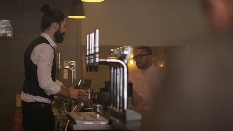 4K Friendly Bartender Serving &amp; Chatting With Customer In City Bar Stock Footage 75761527