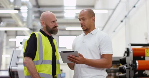 4K Friendly business manager in printing factory giving instructions to employee Stock Footage 68929685