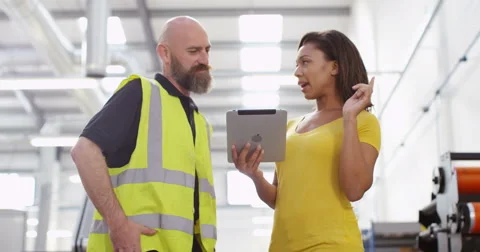 4K Friendly business manager in printing factory giving instructions to employee Stock Footage 68930898