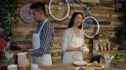 4K Friendly cafe owner couple serving customer &amp; taking contactless payment Stock Footage 76608277