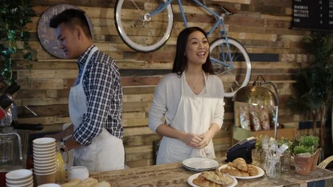 4K Friendly cafe owner couple serving customer &amp; taking contactless payment Stock Footage 76608849