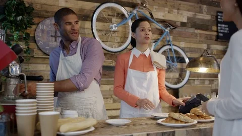 4K Friendly cafe owner couple serving customers &amp; taking contactless payment Stock Footage 76683503