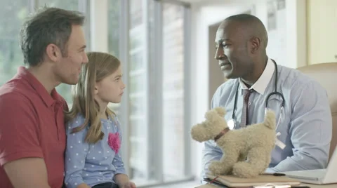 4K Friendly doctor talking to parent and child patient in office Stock Footage 56175080