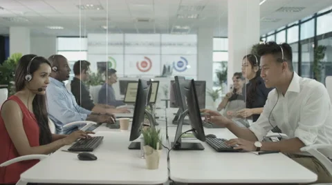 4K Friendly financial advice team taking calls in busy call center Stock Footage 64601663