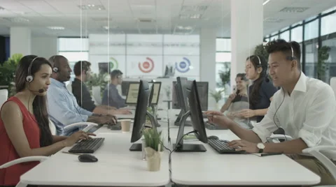 4K Friendly financial advice team taking calls in busy call center Stock Footage 64601918