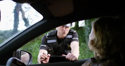 	4K Friendly traffic cop leaving relieved female driver to go on her way Stock Footage 113230609