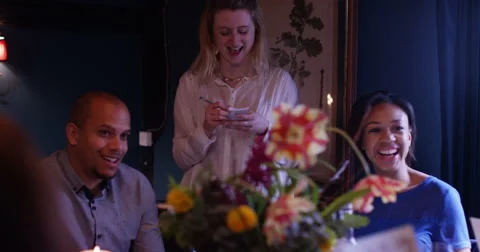 4K Friendly waitress taking order from happy friends in elegant restaurant Stock Footage 62874151