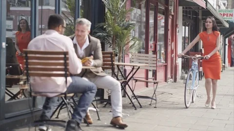 4K Friends With Computer Tablet At Cafe Table Stare As Attractive Woman Walks By 動画素材 75736643
