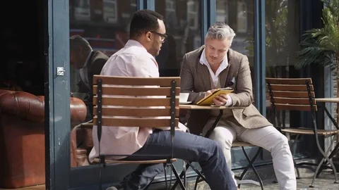 4K Friends With Computer Tablet At Cafe Table Stare As Attractive Woman Walks By Stock Footage 75737548