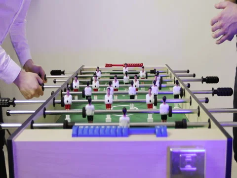4K Friends having fun playing in kicker table football soccer. Stock Footage 73862089