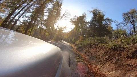 4K Front side view of the car driving on asphalt road on a sunny day Stock Footage 118650473