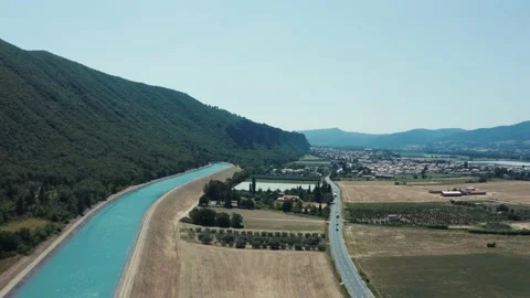 4k front tracking shot on a canal at the foot of a mountain and a forest Stock Footage 166020919