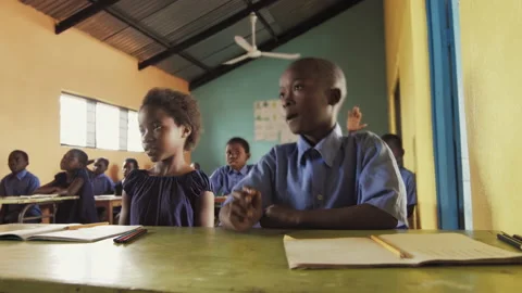 4k Front view of African pupils / students raising hand in class to answer teach Stock Footage 199625650