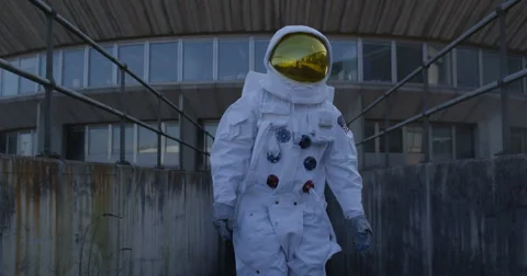 4K Funny astronaut doing a dance as he walks away from mission control building. Stock Footage
