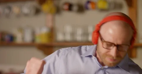 4k, Funny man with wireless headphones listening to music Stock Footage 128407088