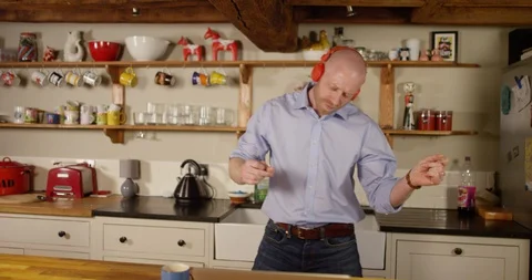 4k, Funny man with wireless headphones listening to music Stock Footage 128407619