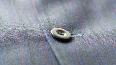 4k of Gentleman's suit jacket close up to buttons. Cam moves to the up Stock Footage 77444252