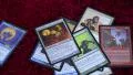 4K German Magic the Gathering cards (MTG) thrown on a pile on a red background 4k or 4k+ Resolution