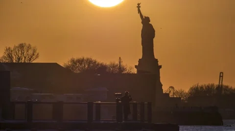 4K Giant sun setting on Statue of Liberty Stock Footage 57202336