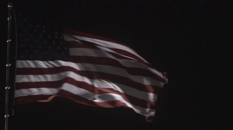 4K: Giant US Flag Waves at Night Against a Black Sky Video stock 63086445