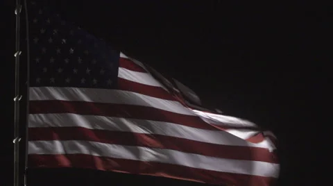 4K: Giant US Flag Waves at Night Against a Black Sky Video stock 63086484