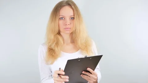4k. Girl taking notes in the tablet. Isolated on white background. Mockup Stock Footage 81471379