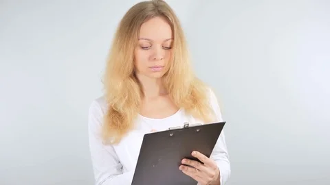 4k. Girl taking notes in the tablet. Isolated on white background. Mockup Stock Footage 81476739