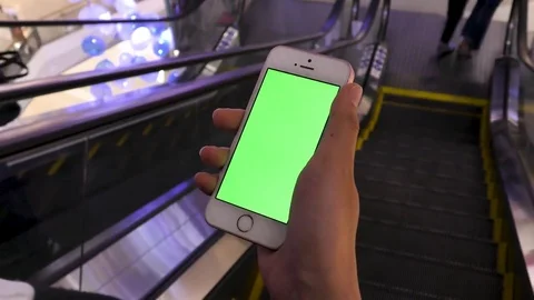 4K Girl using smartphone on escalator in department store and watch on witt.. Stock Footage 75441146