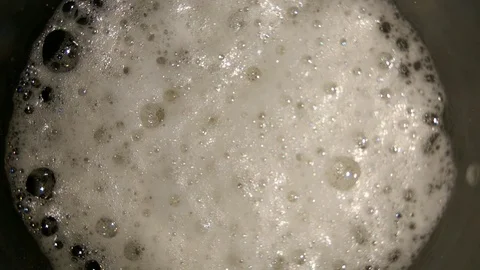 4K Glass of beer with bubbles top view. Beer foam bubbles closeup Stock Footage 105773885