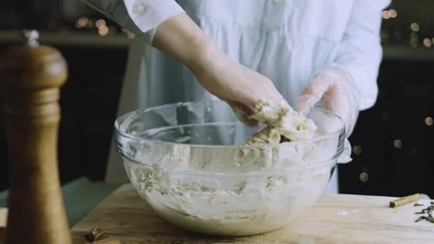 4K Gloved Hand Kneading Gingerbread Dough Inside a Clear Bowl Stock Footage 342113184