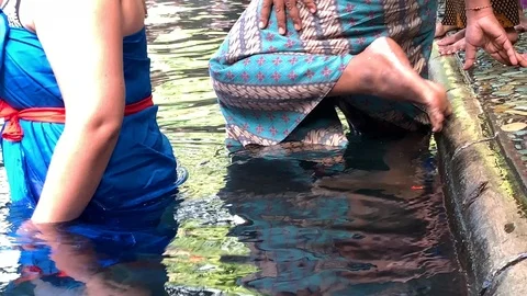 4K going in purification bath pool holy water spring temple pura tirta empul Stock Footage 107847395