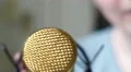 4K Gold microphone shoved in camera, blurred caucasian face speaks aggresivly 4k or 4k+ Resolution