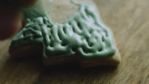 4K Green Icing Pattern Piped Across a Tree-shaped Cookie Stock Footage 342113540