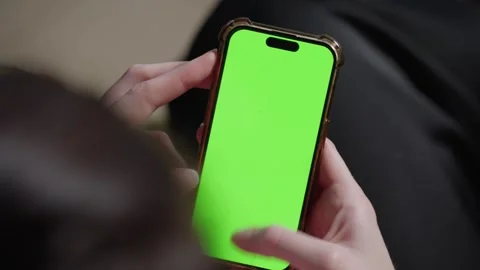 4K green screen footage of an iPhone 15 shot with a Sony FX6 camera, ideal Stock Footage 284958148