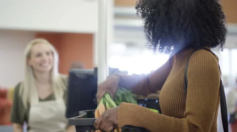 4K Grocery store worker scanning &amp; packing customer's shopping at the checkout Stock Footage 67921283
