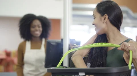 4K Grocery store worker scanning &amp; packing customer's shopping at the checkout Stock Footage 67927080