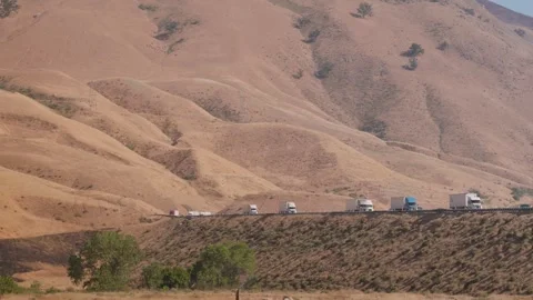 4K Ground Level View of Heavy Truck Traffic on I-5 Through North Tejon Pass Stock Footage 316794833