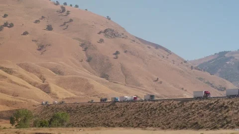 4K Ground Level View of Heavy Truck Traffic on I-5 Through Tejon Pass California Stock Footage 316794864