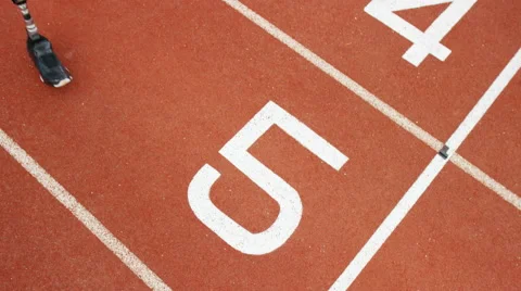 4K Group of athletes (disabled &amp; able bodied) celebrate victory on running track Stock Footage 56481181