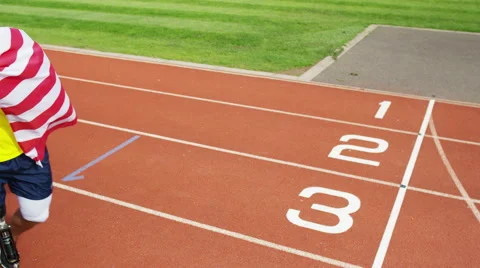 4K Group of athletes (disabled &amp; able bodied) celebrate victory on running track Stock Footage 56483780