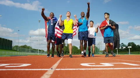 4K Group of athletes (disabled &amp; able bodied) celebrate victory on running track Stock Footage 56484857
