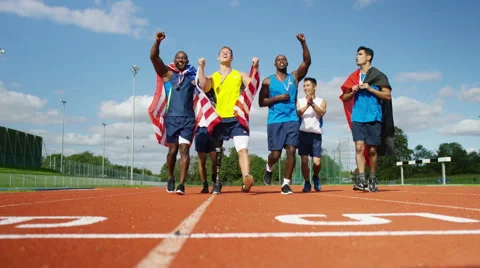 4K Group of athletes (disabled &amp; able bodied) celebrate victory on running track Stock Footage 56486617