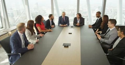 4k, Group of business persons having a meeting around a large table in an office Stock Footage