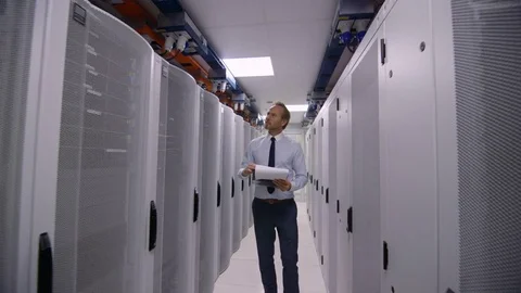 4K Group of computer technicians checking machines in a data center server room Stock Footage 75048315