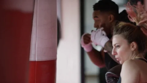 4K Group of diverse fighters training on punch bags in a gym Video stock 73398665