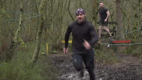 4K: Group of male runners in a Tough Mudder mud run / Obstacle course. Stock Footage