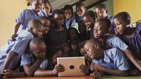 4k of group of pupils viewing a touch screen tablet computer in African class ro Stock Footage 199625318