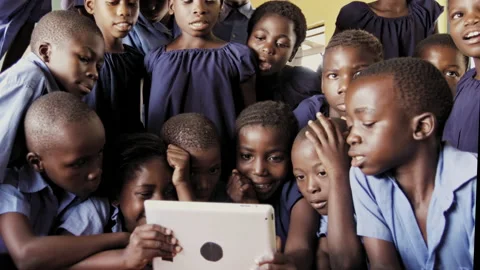 4k of group of pupils viewing a touch screen tablet computer in African classroo Stock-Footage 199625346