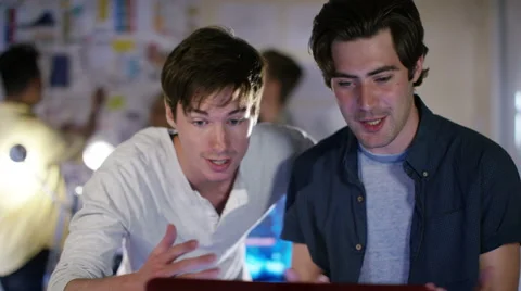 4K Group of young male computer programmers working together in small office Stock Footage 54430076